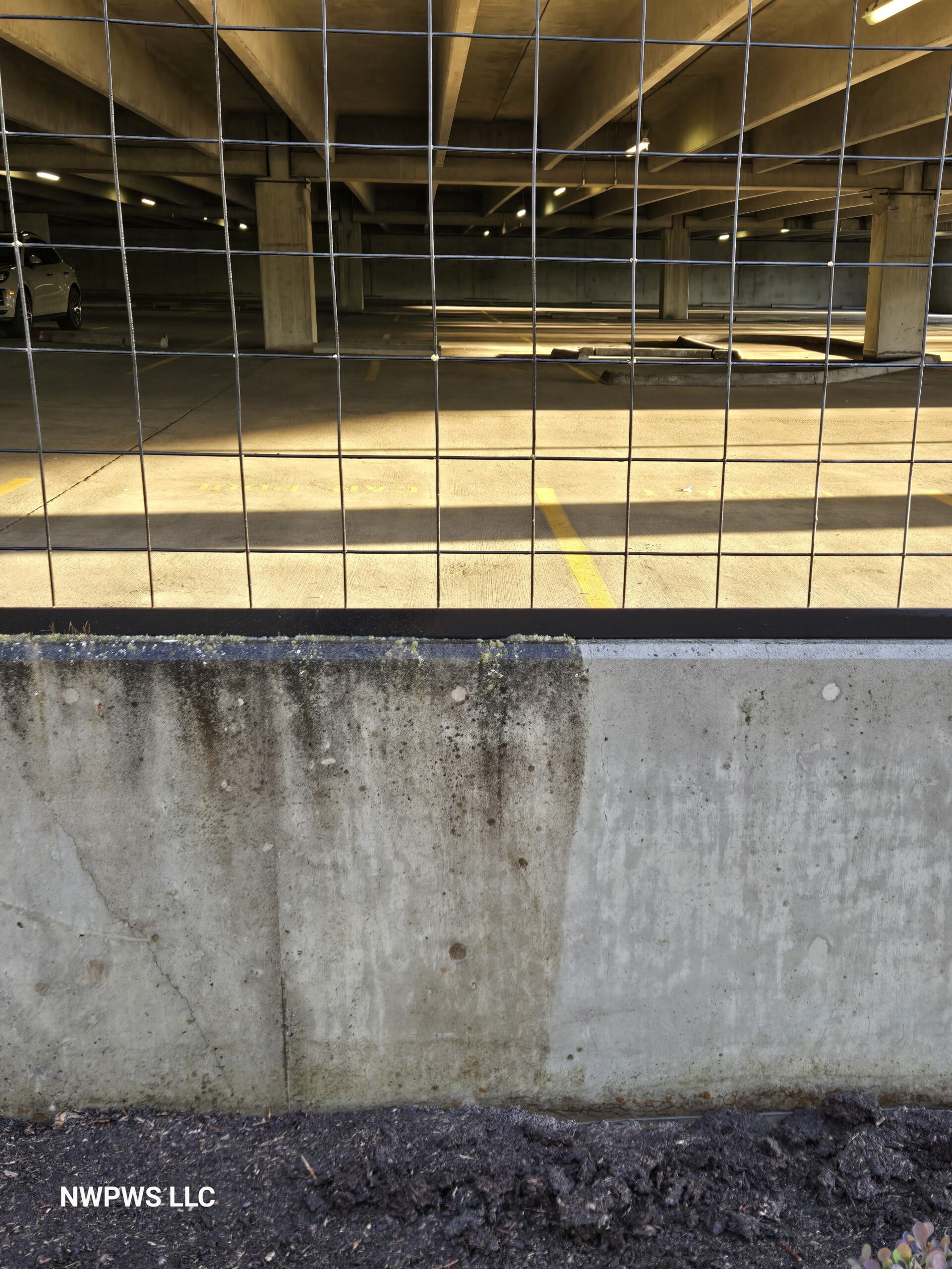 Before and After image pressure washing parking garage