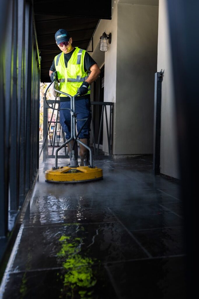 a man in a yellow vest is pressure washing Chesterfield County, VA