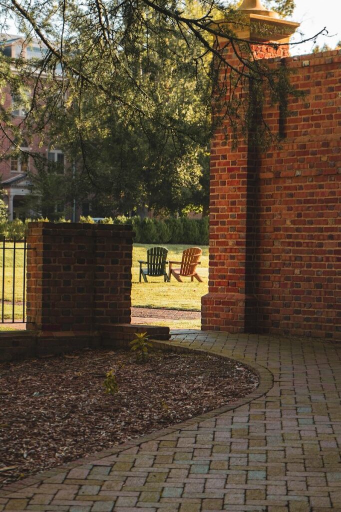 a brick walkway with a chair in the background. Williamsburg, VA Pressure Washing